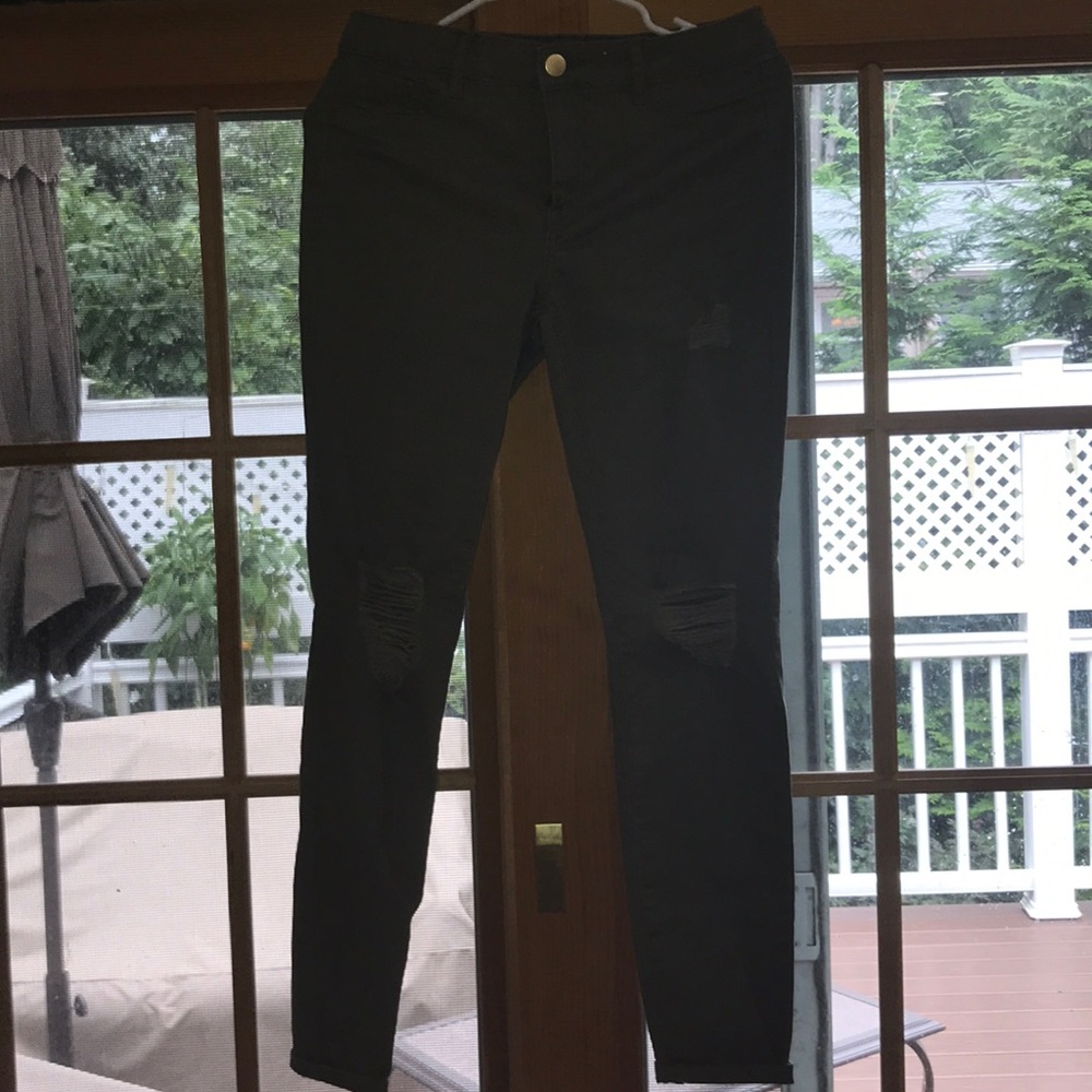 Hunter green jeans with ripped knees